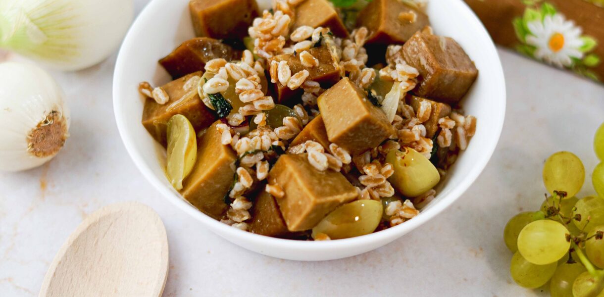 seitan con farro nella ciottola e uva