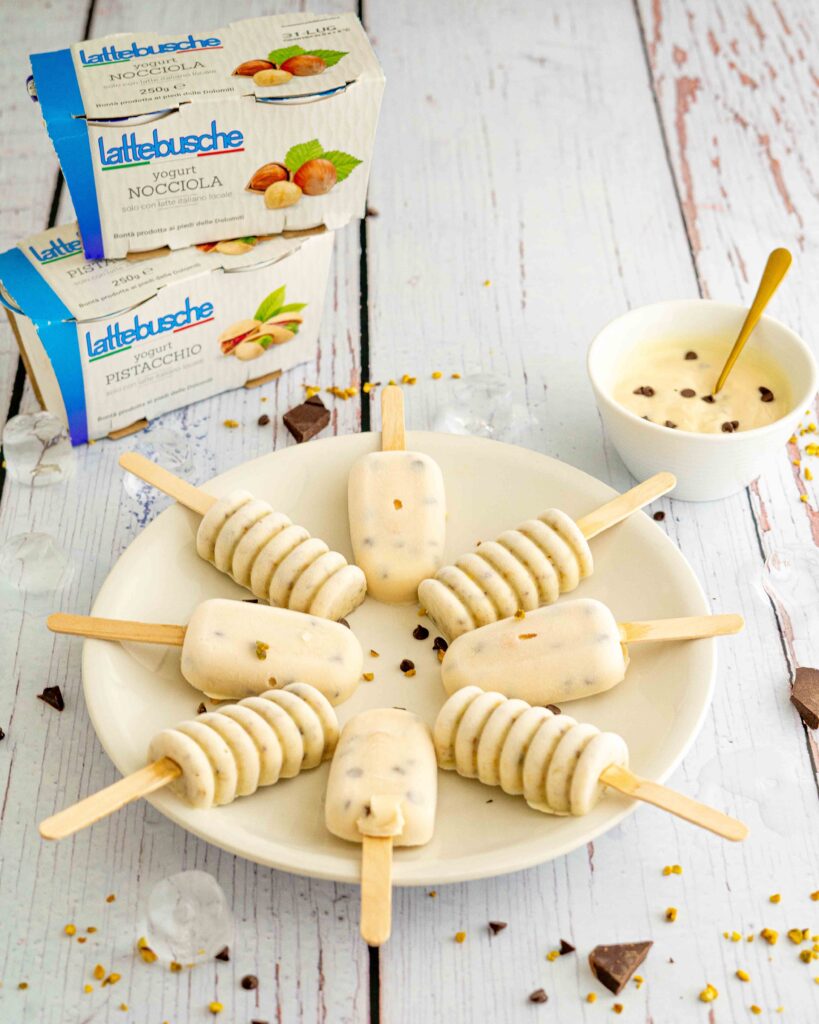 gelati sul piatto misti, sul tavolo cioccolato a pezzi e ghiaccio, ciottola con yogurt e confezioni di yogurt sul tavolo